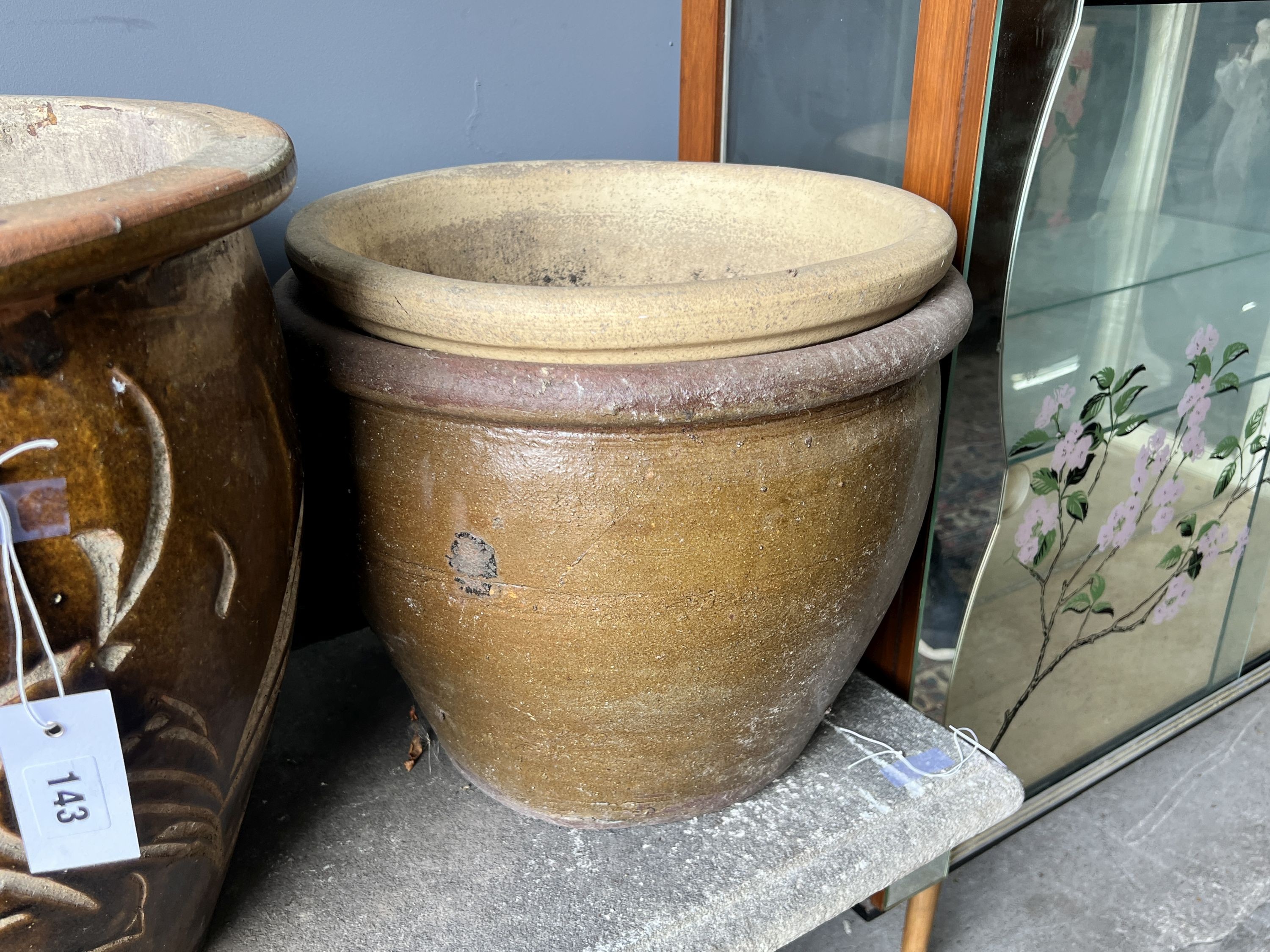 Four circular glazed earthenware garden planters, largest diameter 42cm and height 39cm